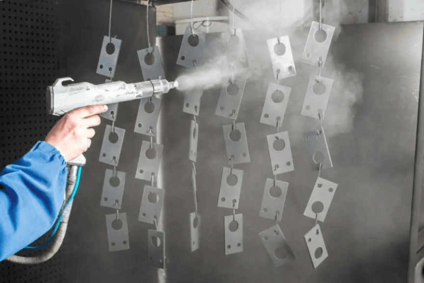 Understanding Teflon Coating: A Game-Changer for Precision Manufacturing 1 a person spraying metal plates with smoke